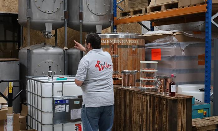 Dan giving a distillery tour and showing the stills.